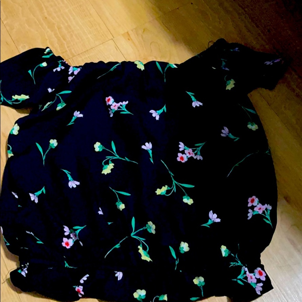 A black blouse with flowers on it